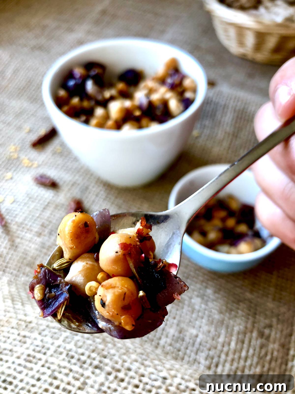 Garlic Lemon Sautéed Chickpeas with Crispy Edges 3 Closeup of a tablespoon full with sauteed chickpeas.