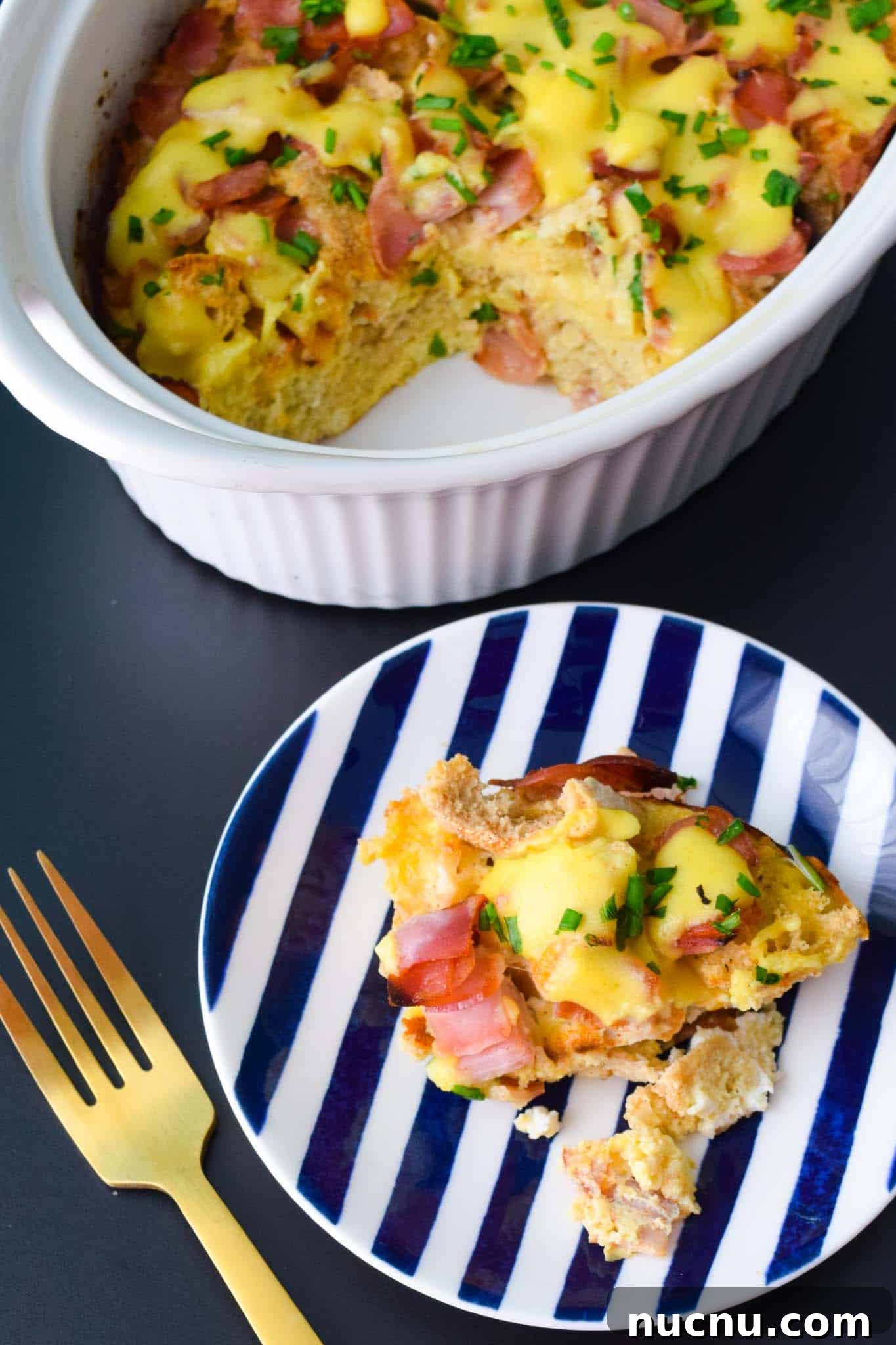 Overnight Eggs Benedict Casserole Recipe for Brunch Crowd 6 Overnight Eggs Benedict Casserole served in blue and white striped plate overhead shot