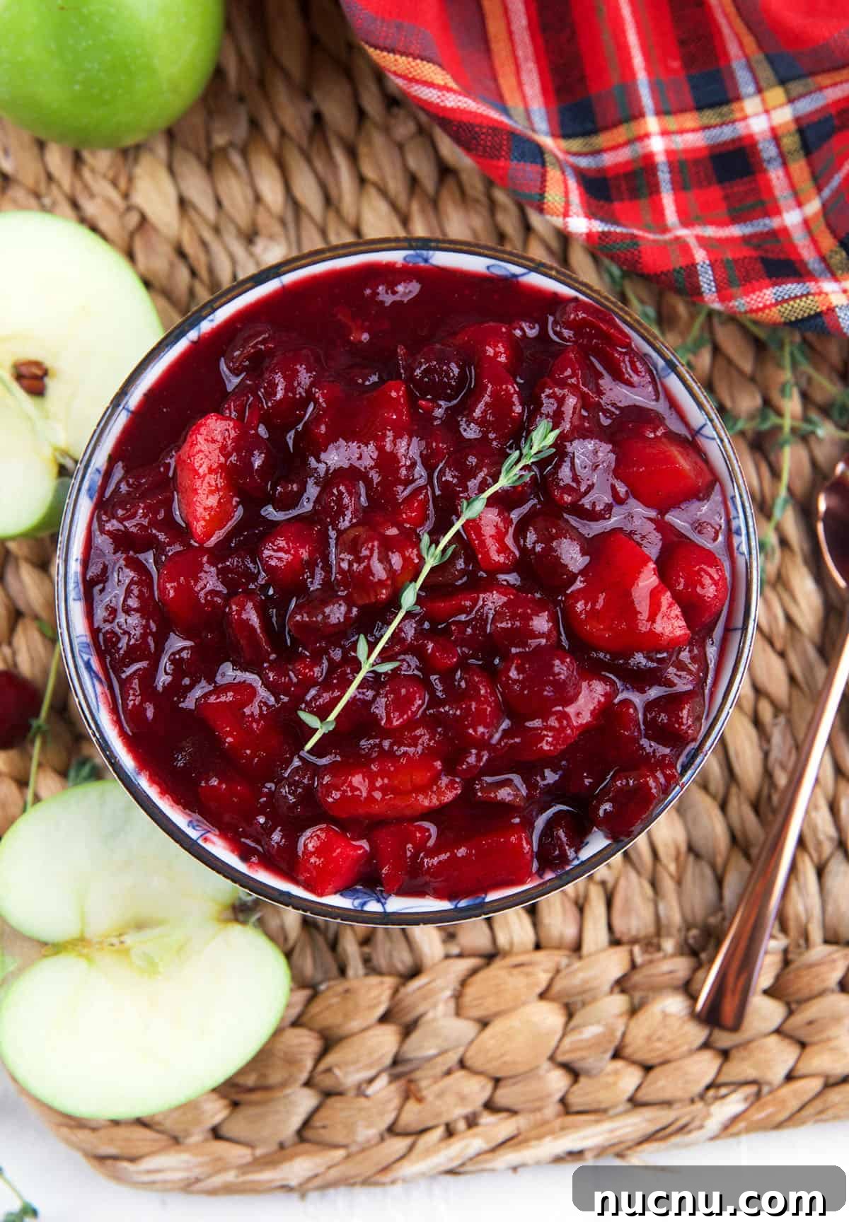 Tangy Cranberry Chutney Recipe for Holiday Roasts and Cheese 4 Halved apples are placed next to a bowl of chutney.