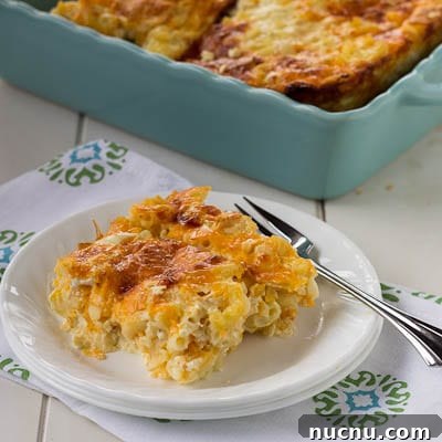 Creamy Baked Macaroni and Cheese Casserole Recipe 4 Slice of Baked Mac and Cheese on a plate with a fork.