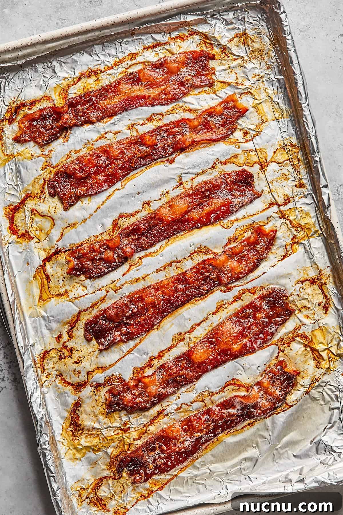 cooked bacon on a baking sheet