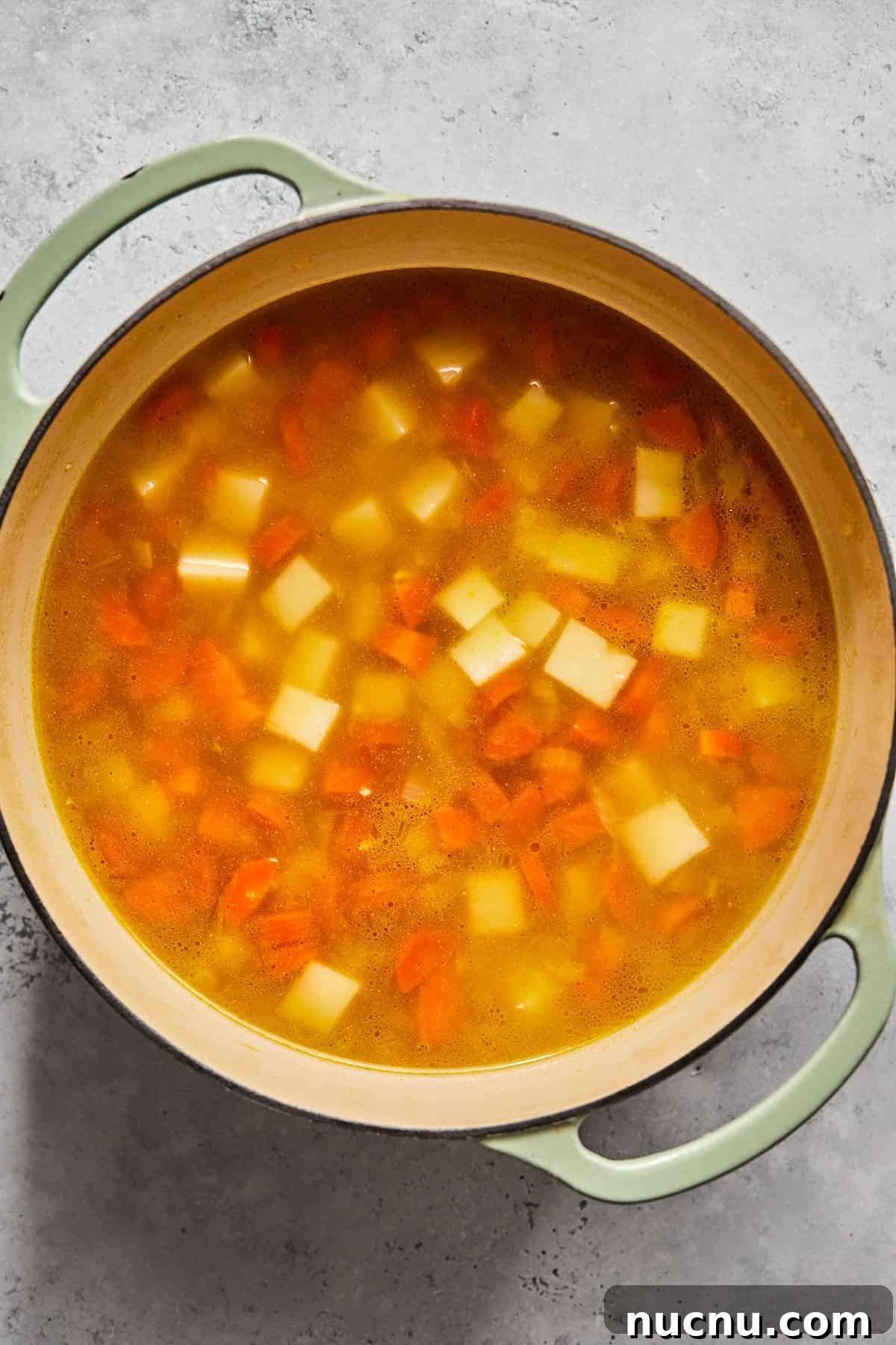 broth, potatoes and carrots in a pot