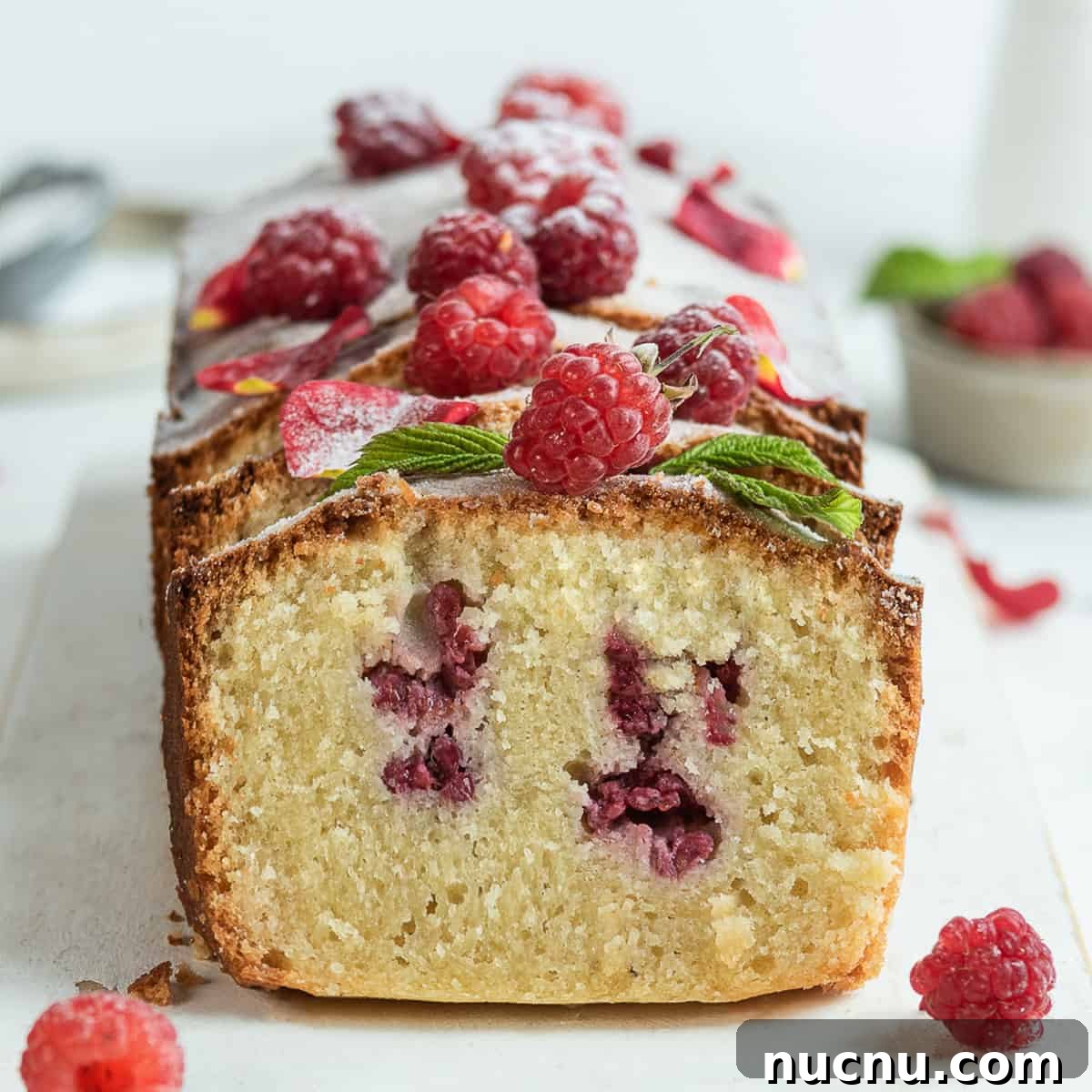 Ispahan Raspberry Loaf Cake Recipe for Elegant Tea-Time Treat 2 Sliced raspberry loaf cake Ispahan on a white serving board