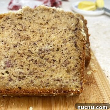 Sliced no sugar added banana bread on a wooden board.