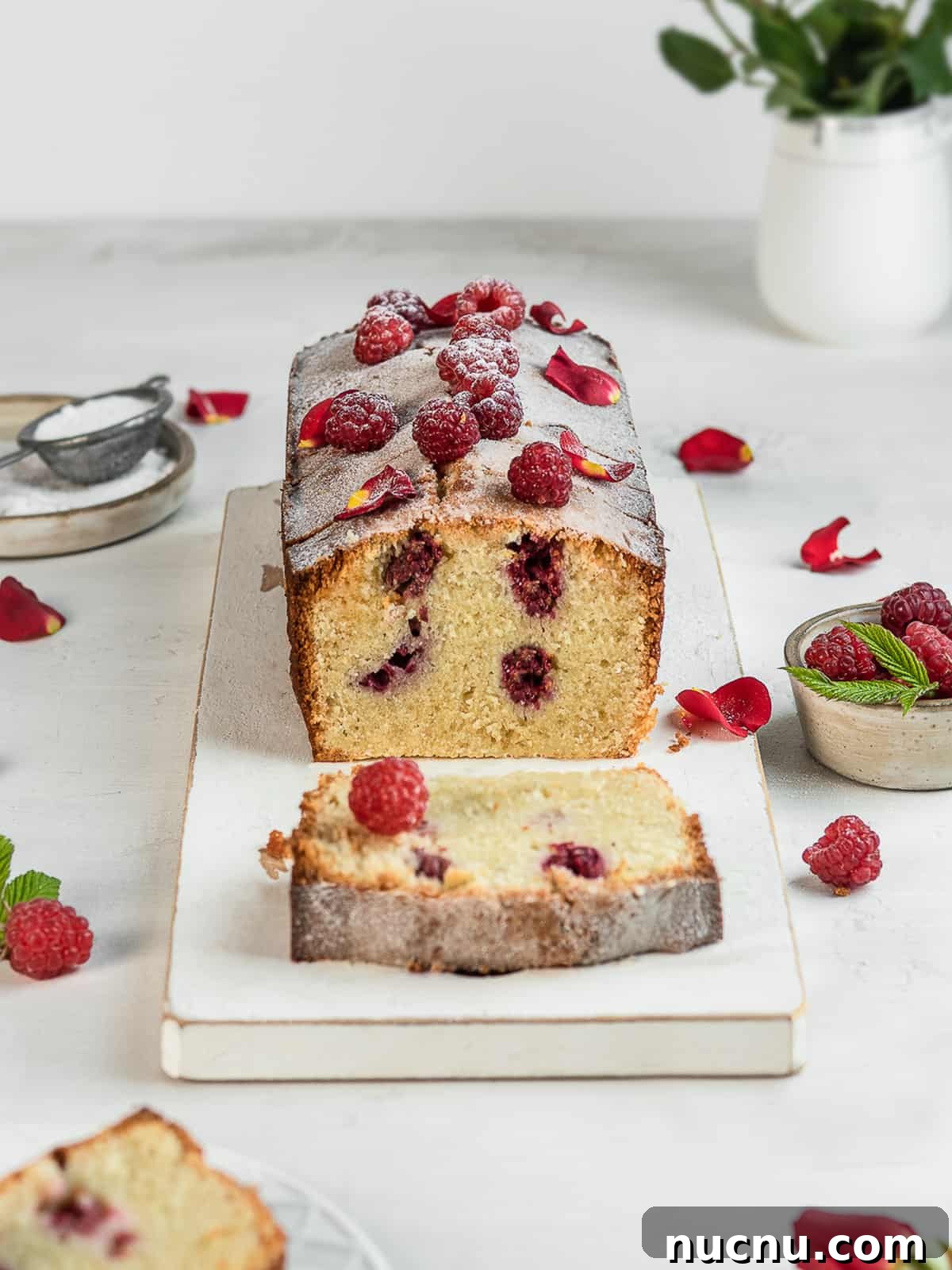Ispahan Raspberry Loaf Cake Recipe for Elegant Tea-Time Treat 3 Ispahan cake topped with fresh raspberries on a white serving platter