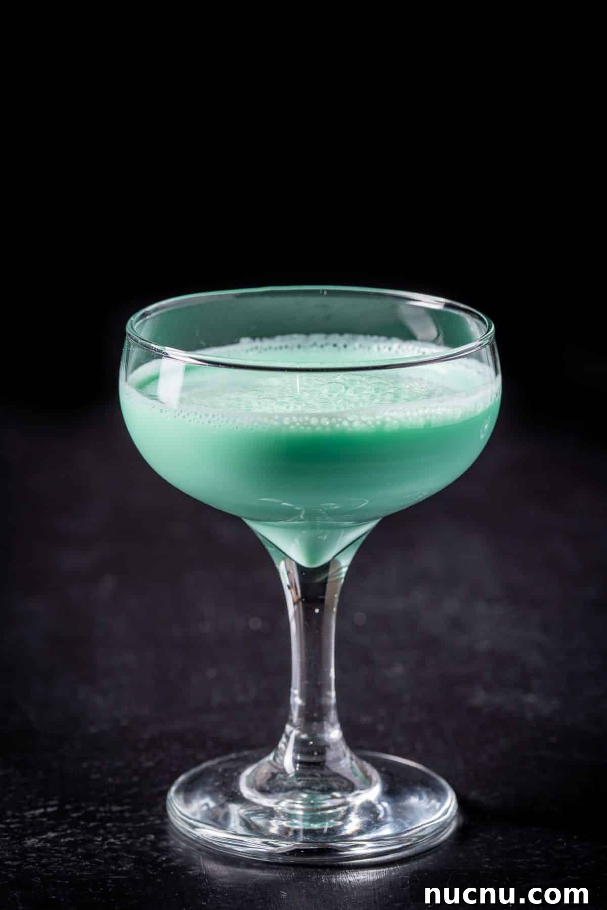 Close up on a coupe glass with the grasshopper cocktail