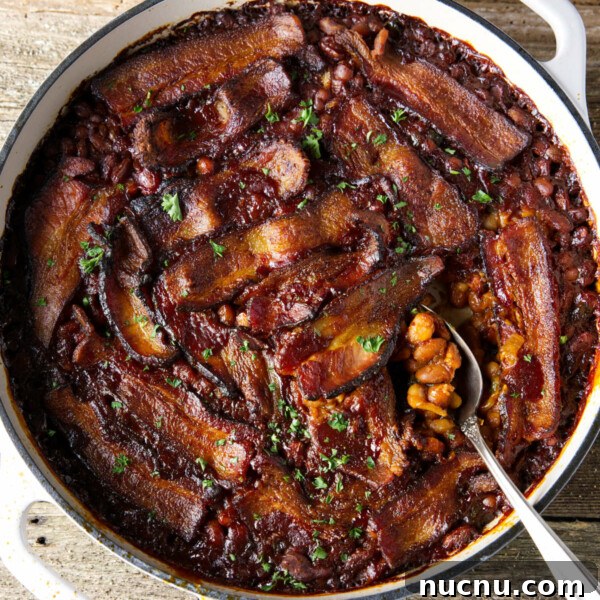 Savory Pork Butt Dry Rub Recipe for Juicy Barbecue 13 smoked baked beans in dutch oven with bacon laid on top