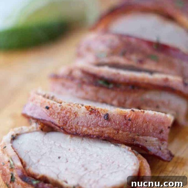 Savory Pork Butt Dry Rub Recipe for Juicy Barbecue 9 Bacon wrapped pork tenderloin cut into slices on wood cutting board