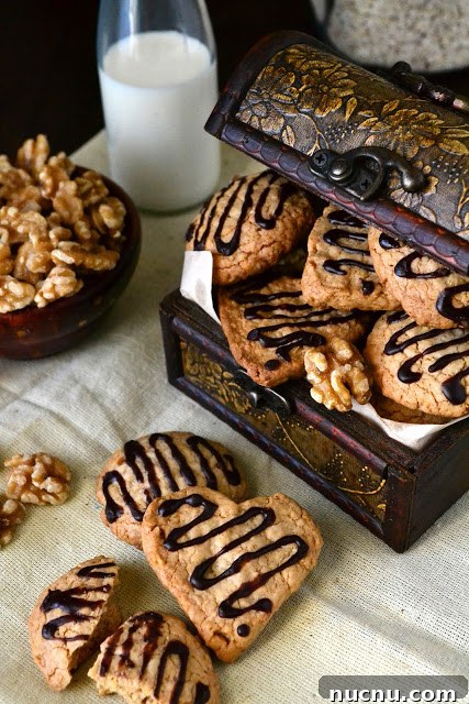 Chewy Oat and Walnut Cookies Recipe 3 Oats and walnut cookies with a bowl of walnuts.