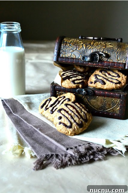 Chewy Oat and Walnut Cookies Recipe 4 oats and walnut cookies with a bottle of milk.