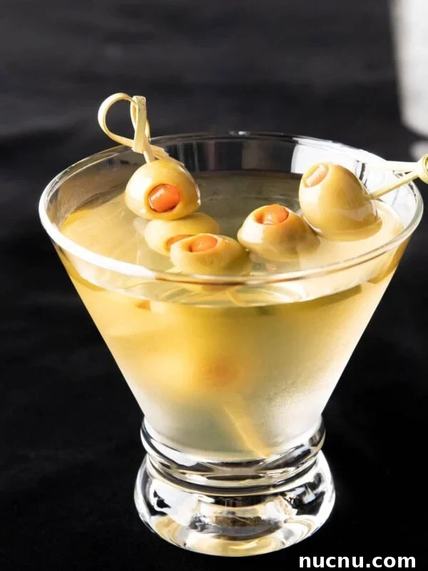 Peppermint Martini Recipe: How to Make a Refreshing Holiday Cocktail 8 Two olive skewers in an extra dirty martini
