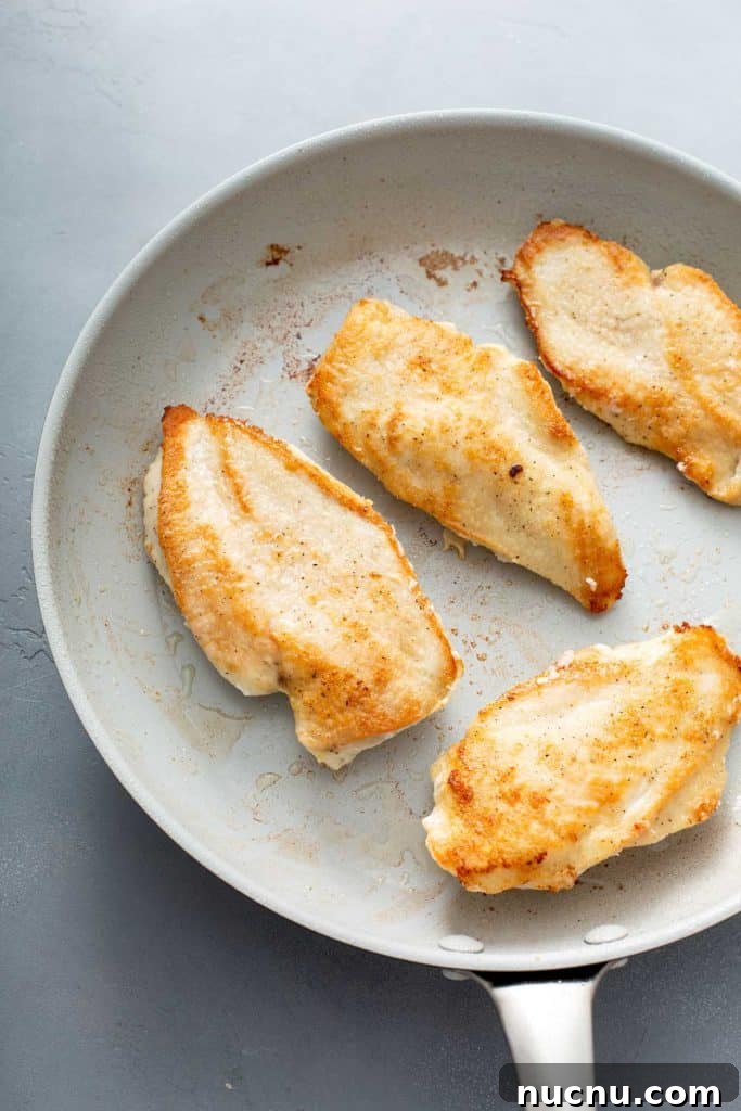 golden brown chicken breasts on a skillet