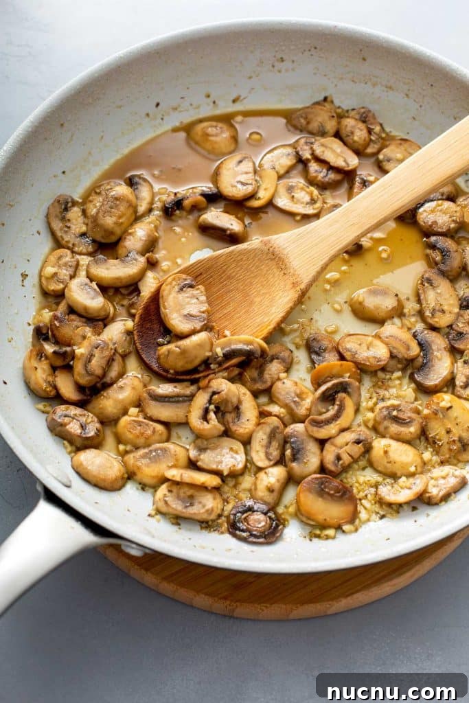 sautéed mushrooms with their juice on a skillet