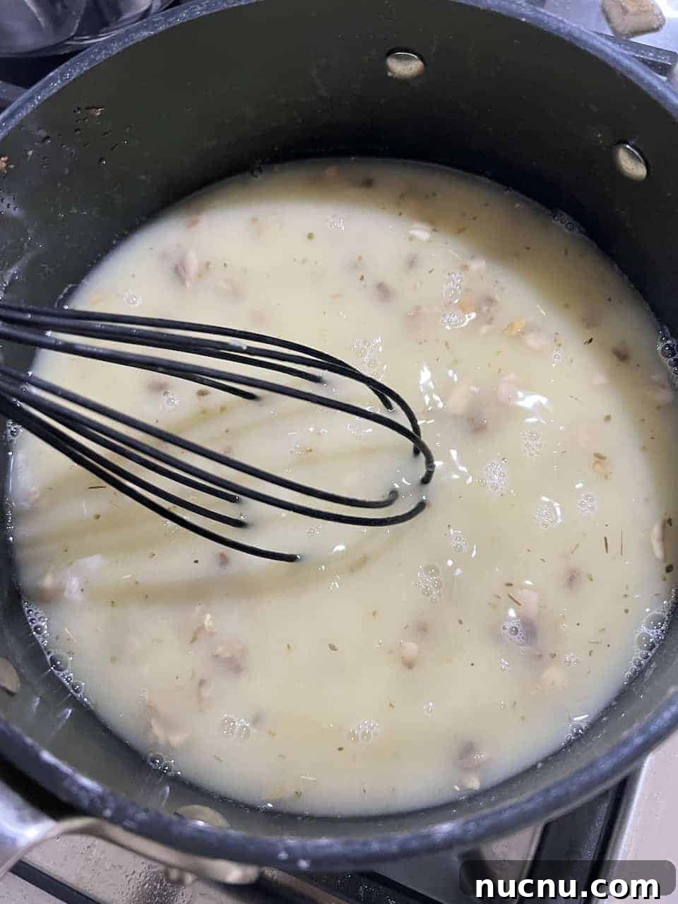 process of mushroom gravy ingredients being mixed in a pan