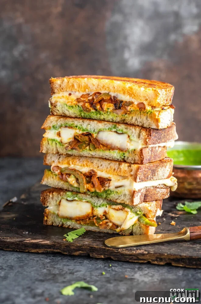 stack of paneer sandwiches cut into half to reveal the inside