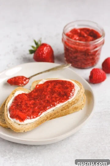 Two slices of toast with cream cheese and jam.