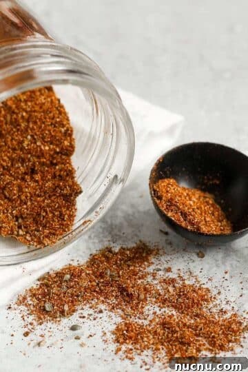 Taco seasoning spilling from a mason jar.