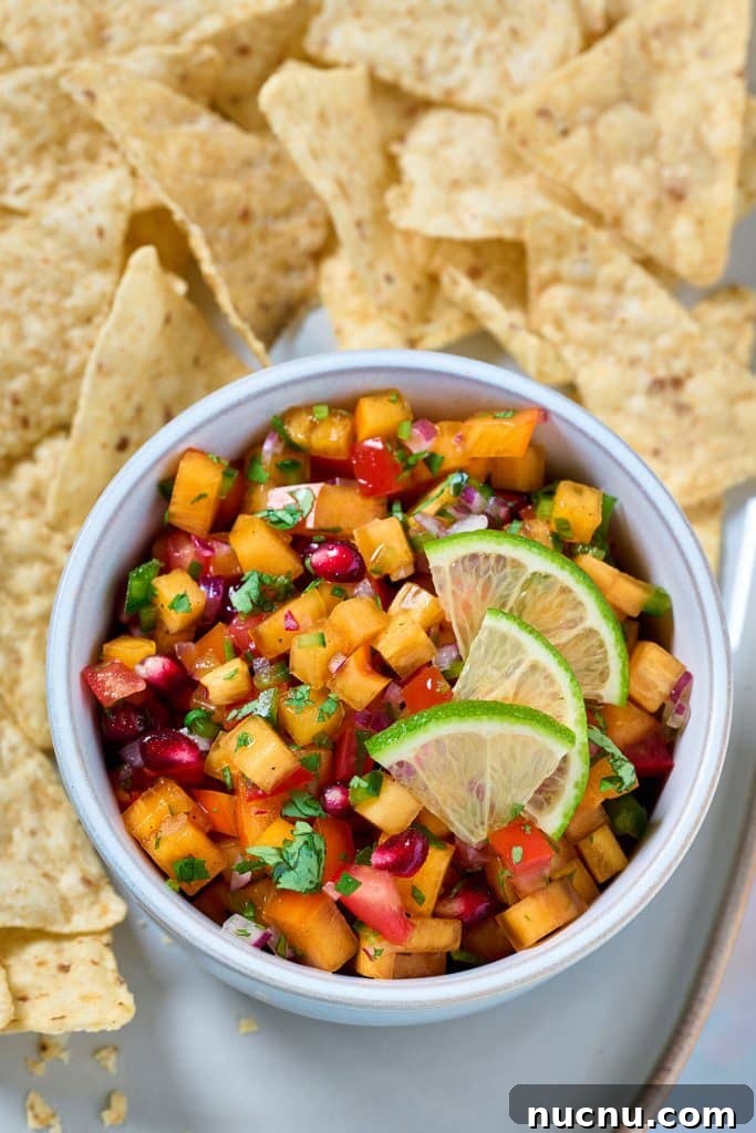 Persimmon Salsa Recipe: Fresh, Tangy Fall Salsa for Chips & Tacos 5 A bowl of persimmon salsa surrounded with tortilla chips