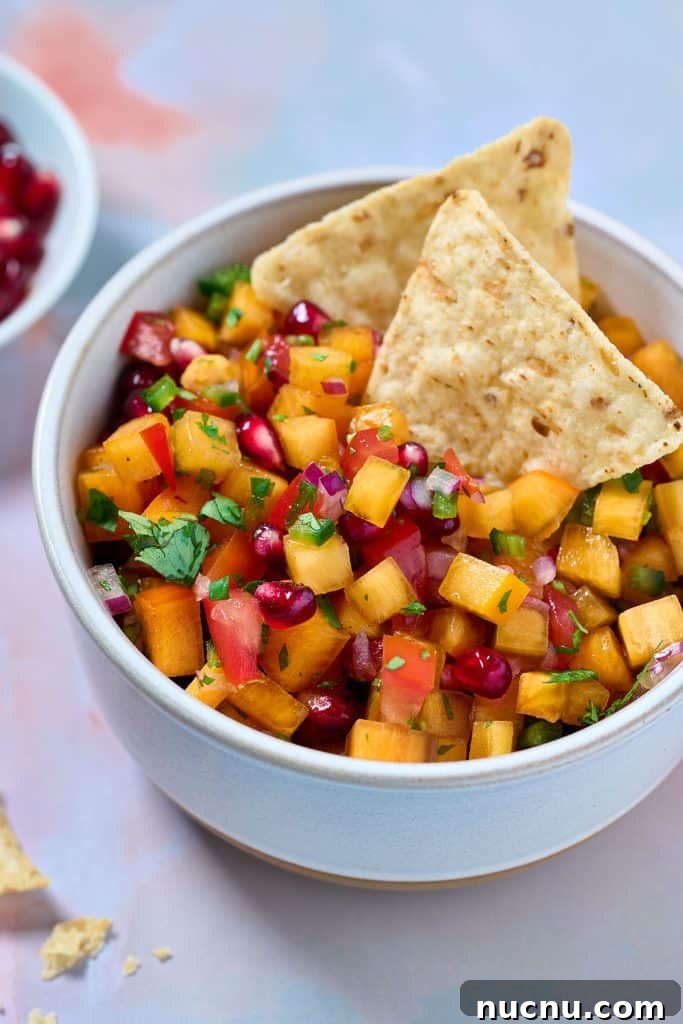 Persimmon Salsa Recipe: Fresh, Tangy Fall Salsa for Chips & Tacos 7 a small bowl with persimmon salsa garnished with tortilla chips.