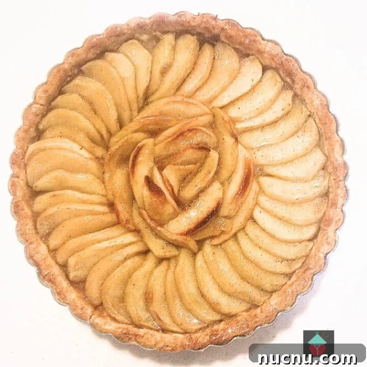 French Apple Tart, a delicious sweet, crumbly pastry tart with slices of apple sitting on a crisp pastry base. Ideal for dessert or to have with tea.