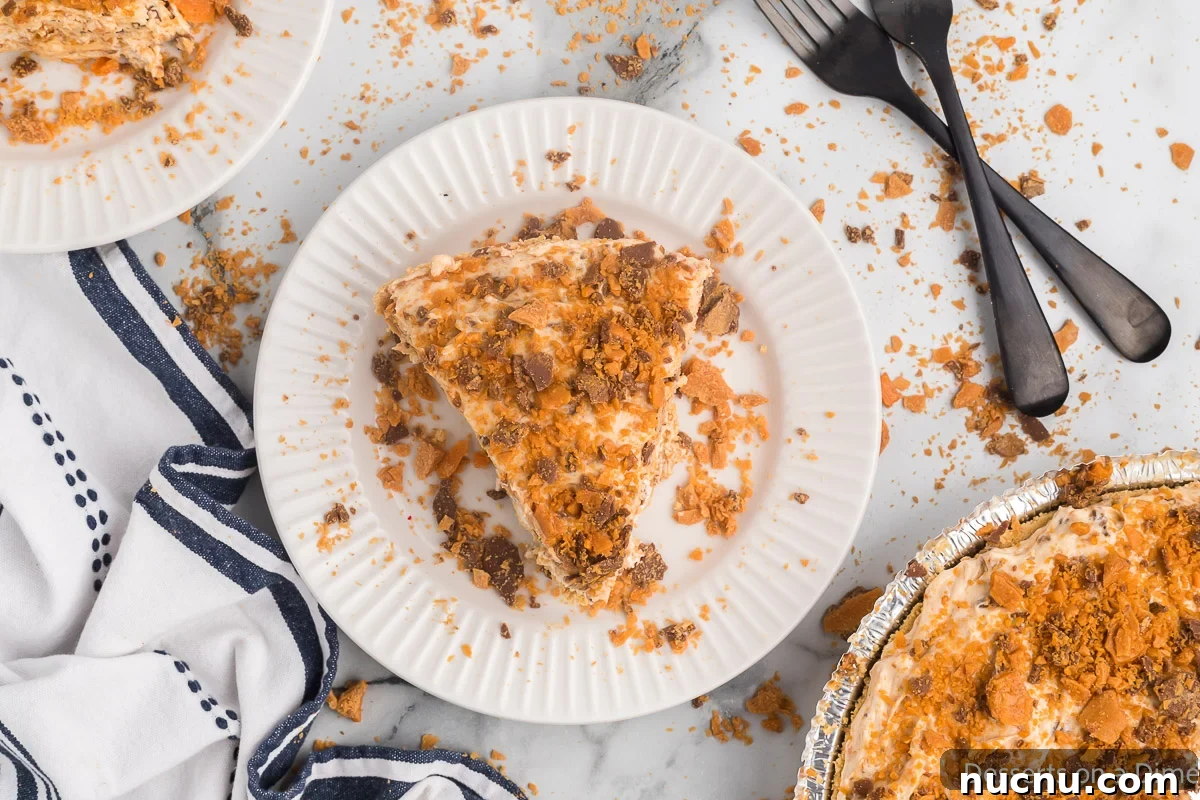Decadent Butterfinger Pie Recipe — How to Make It at Home 2 Slice of Butterfinger pie on a plate.
