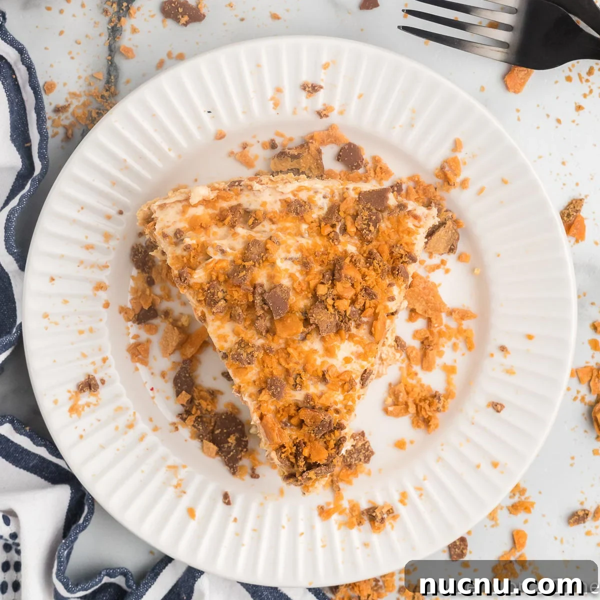 Decadent Butterfinger Pie Recipe — How to Make It at Home 11 Slice of Butterfinger pie on a plate.