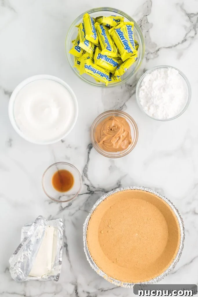 Decadent Butterfinger Pie Recipe — How to Make It at Home 3 Ingredients for Butterfinger Pie- pie crust, cool whip, powdered sugar, peanut butter, cream cheese, vanilla.