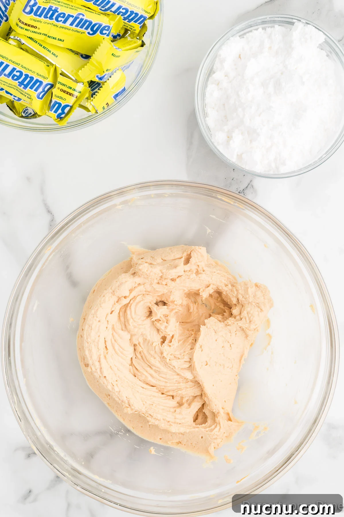 Decadent Butterfinger Pie Recipe — How to Make It at Home 5 Powdered sugar mixed into the peanut butter mixture in a mixing bowl.