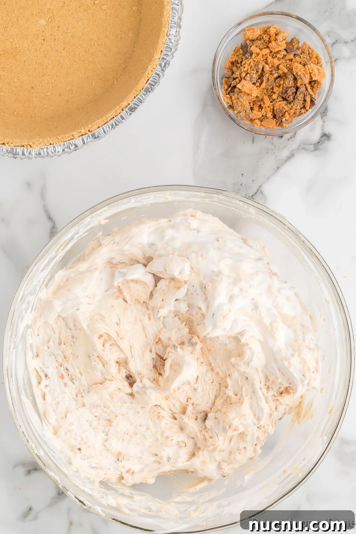 Decadent Butterfinger Pie Recipe — How to Make It at Home 8 Bowl with whipped topping folded into the pie mixture.
