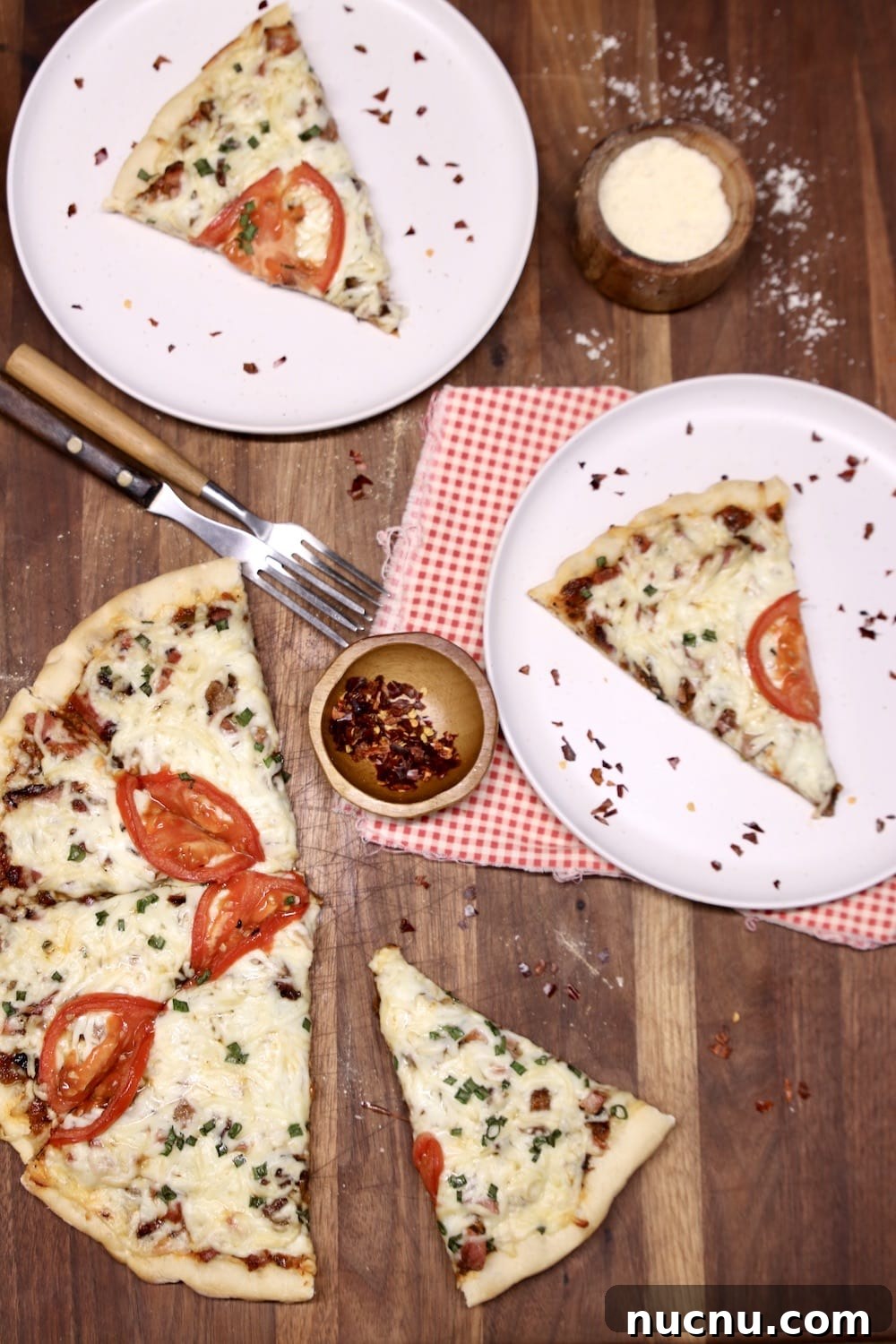 Grilled smoked brisket pizza grilled pizza, sliced, 2 plates with a slice