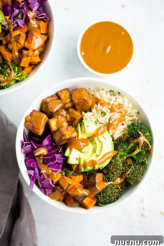 Vibrant Buddha Bowl Recipe: Colorful, Nourishing Lunch Idea 3 buddha bowl from farther away with potatoes, rice, tofu and red cabbage.