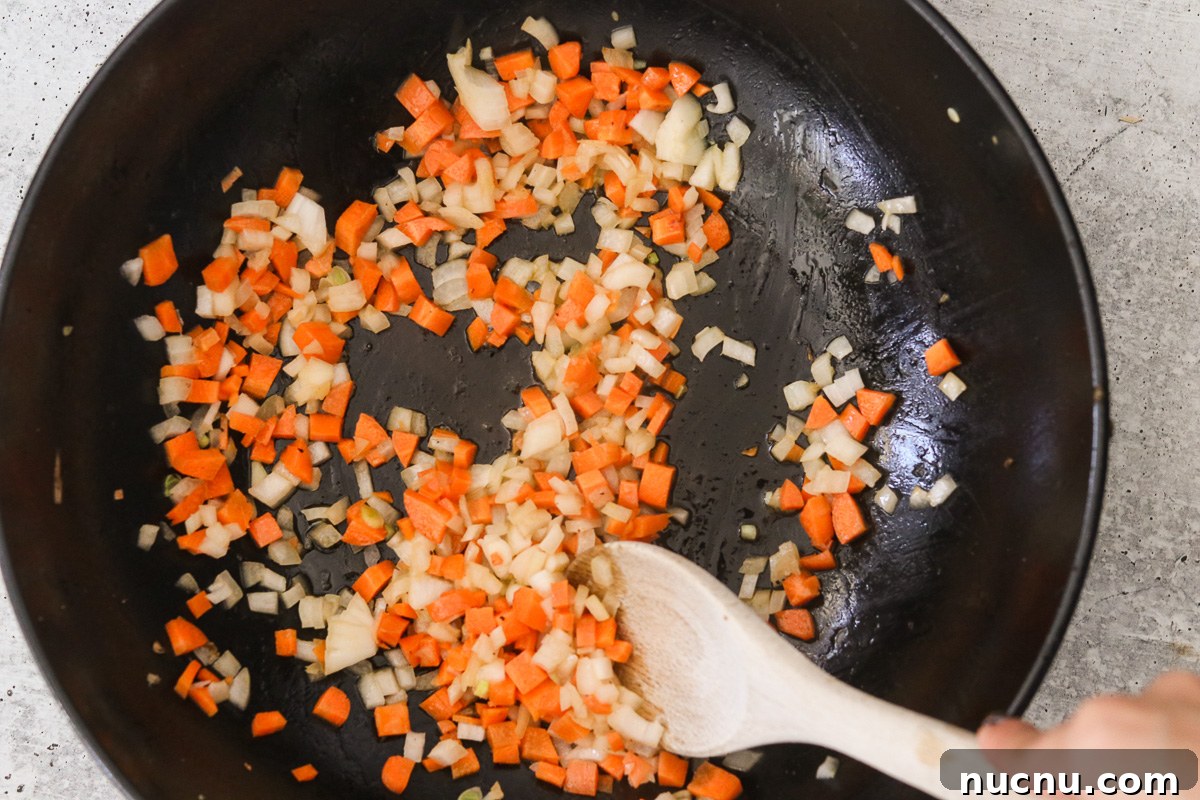 Hibachi Chicken Bowl Recipe — Japanese Steakhouse Copycat 6 Diced carrots and onion sautéing in melted butter in the same skillet.