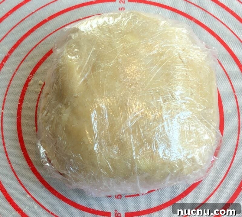 Flaky All-Butter Pie Crust Recipe for Perfect Homemade Pies 3 pie crust disc wrapped in plastic wrap on a silicone mat