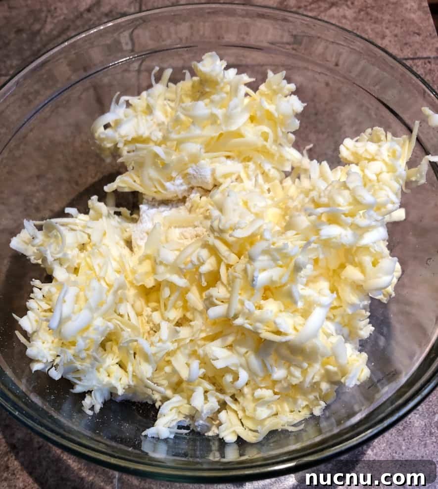 Flaky All-Butter Pie Crust Recipe for Perfect Homemade Pies 4 shredded cold butter in a bowl.