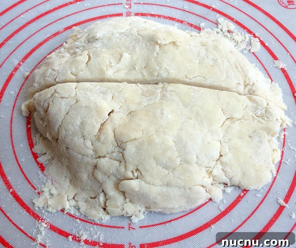Flaky All-Butter Pie Crust Recipe for Perfect Homemade Pies 7 pie crust dough cut in half.