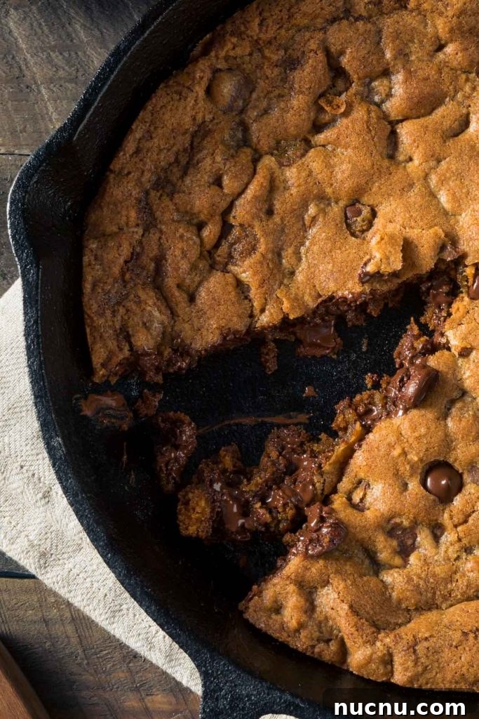 Skillet Chocolate Chip & Toffee Cookie (Pizookie Recipe) 3 a closeup of a pizookie with one slice cut out