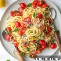 Lemon Pasta with Cherry Tomatoes and Fresh Basil Recipe 9 one-pot lemon pasta with tomatoes and basil on a plate in utensils