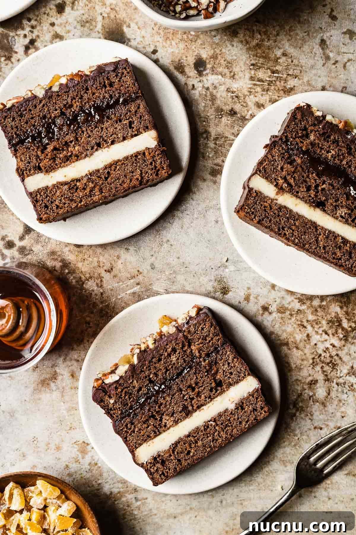 Slices of Polish honey spice cake on tan plates and a brown background.