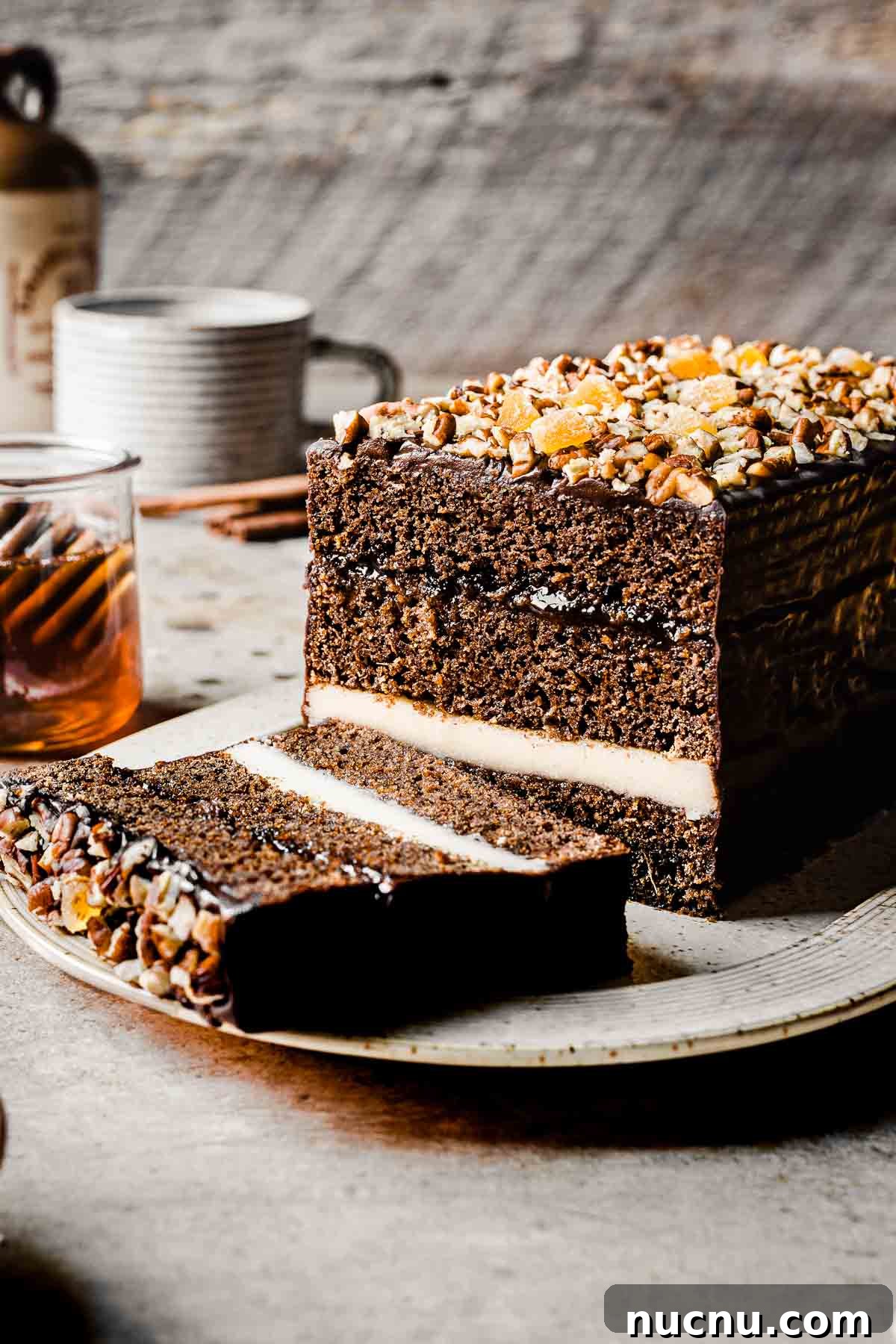 A piernik honey spice cake on a platter with a slice cut off.