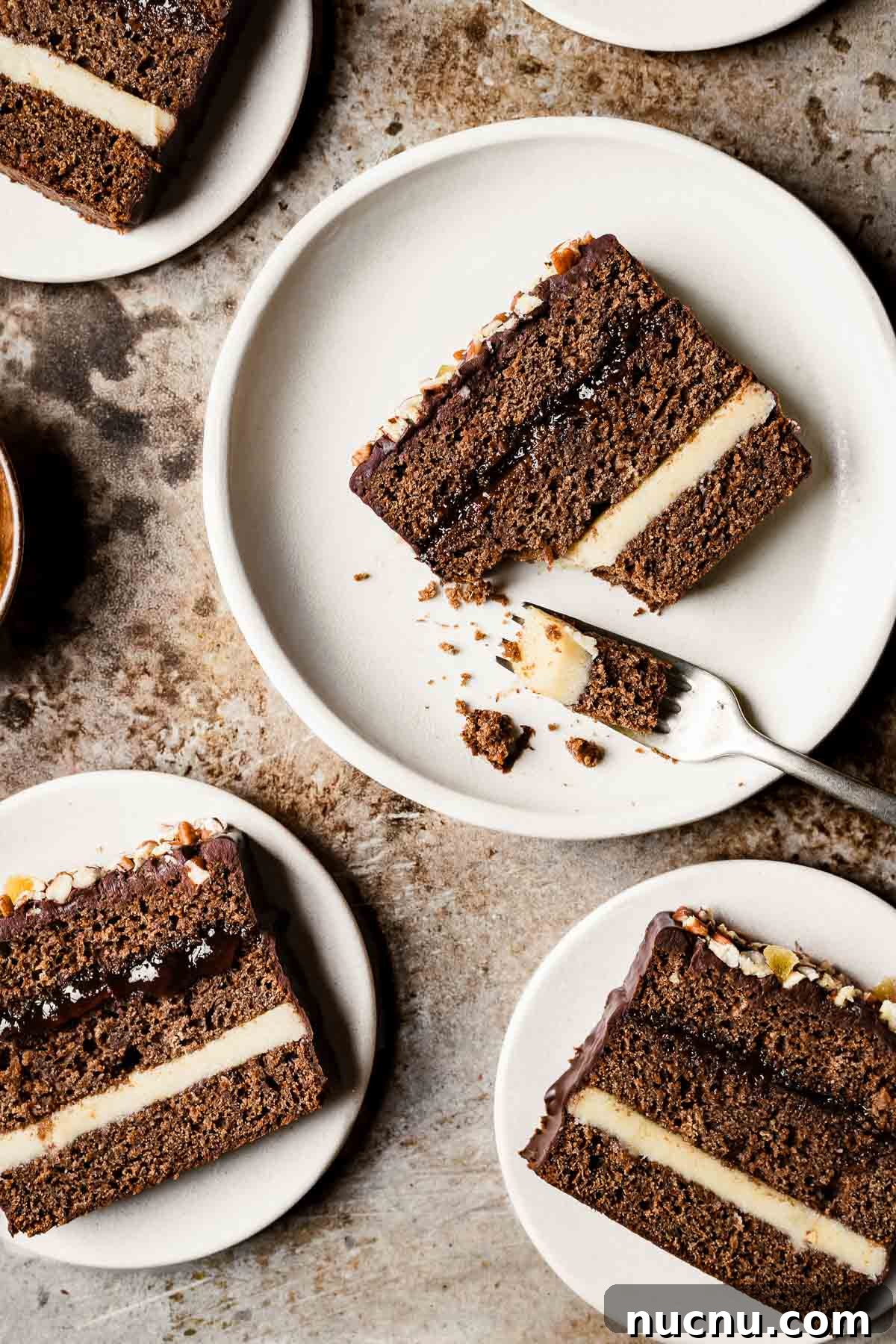 Slices of piernik honey spice cake on tan plates.