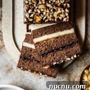 Two slices of filled gingerbread cake on a tan platter.