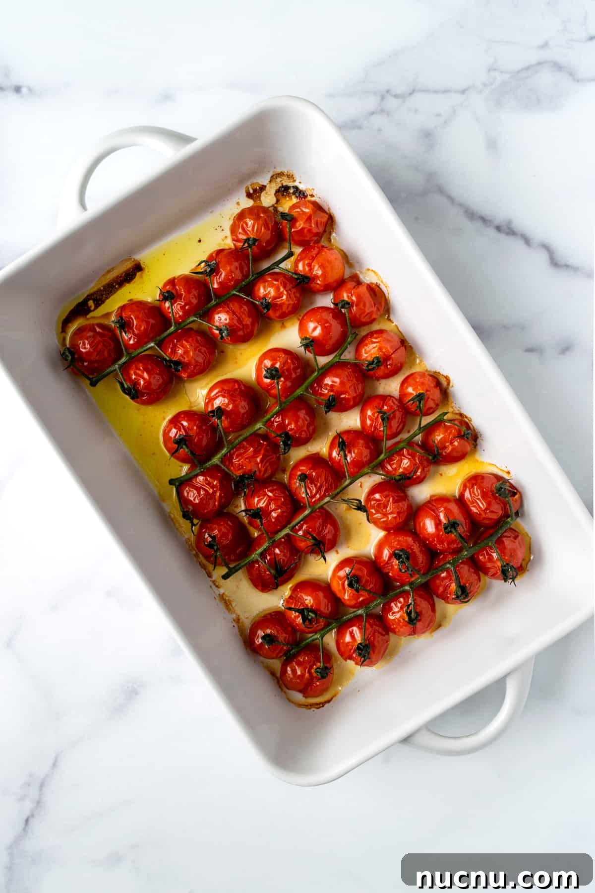 Baked Cherry Tomatoes in a white baking dish.