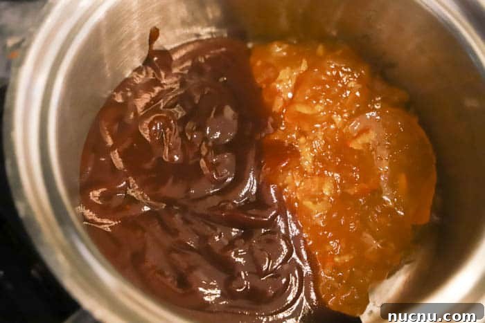 Sticky Orange Chicken Recipe: Crispy, Tangy Takeout at Home 3 bbq sauce and jelly in a saucepan