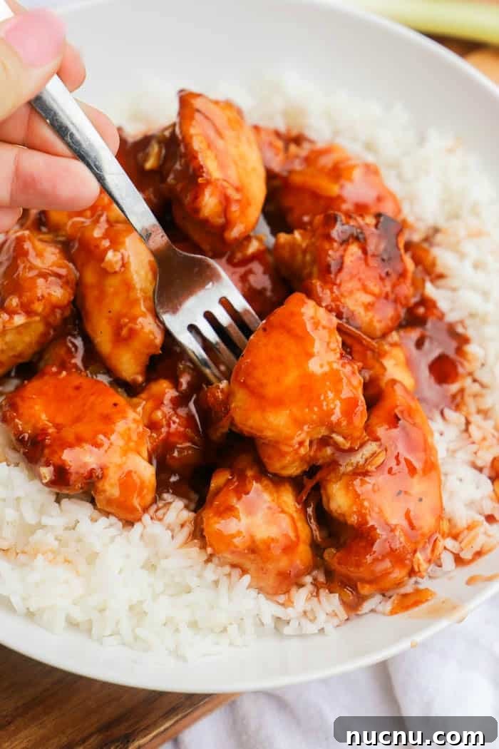 Sticky Orange Chicken Recipe: Crispy, Tangy Takeout at Home 6 Easy Orange Chicken with a fork
