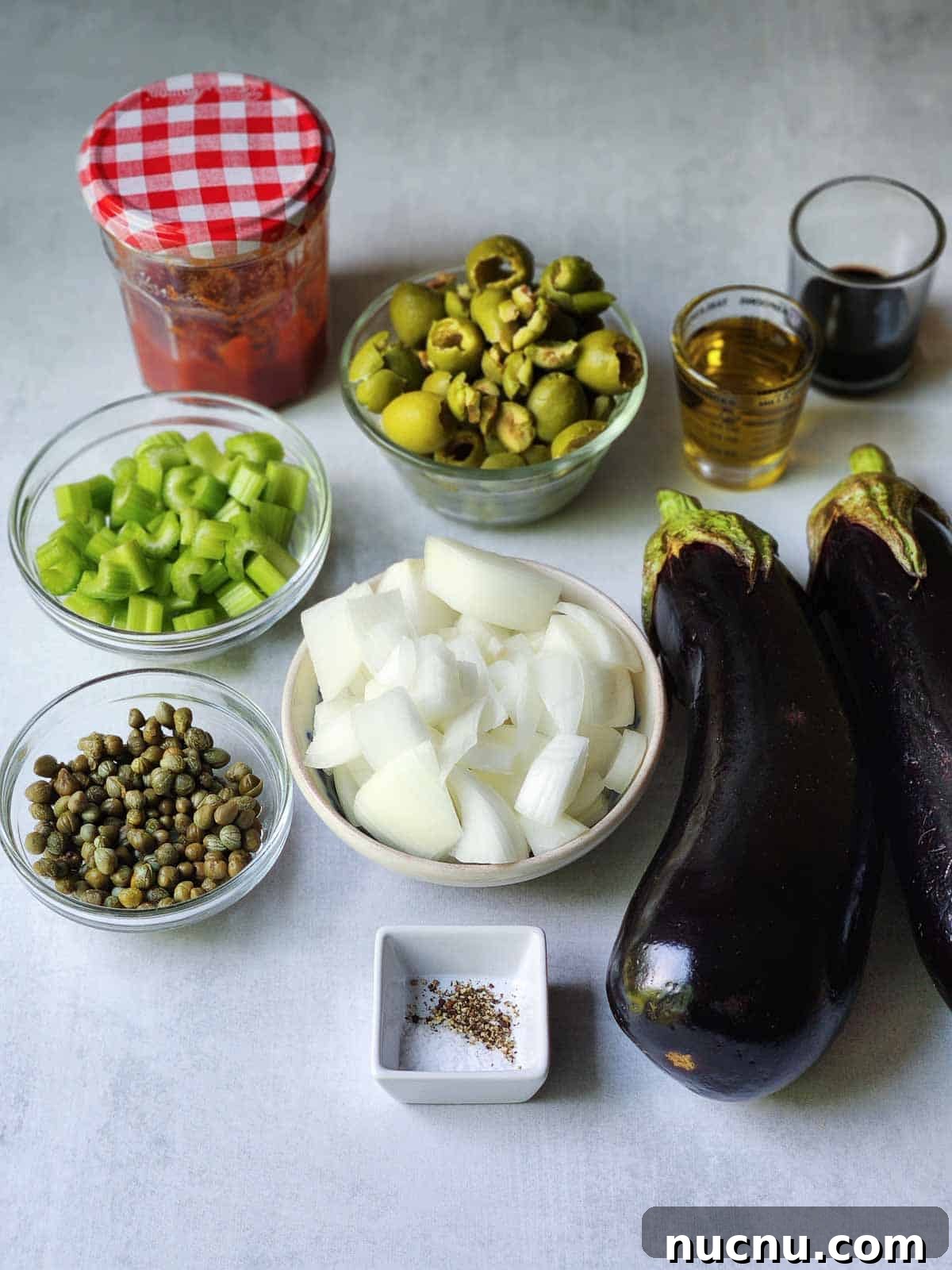Sicilian Eggplant Caponata Recipe: Sweet-Sour Mediterranean Relish 3 Ingredients for Sicilian caponata on a grey surface.