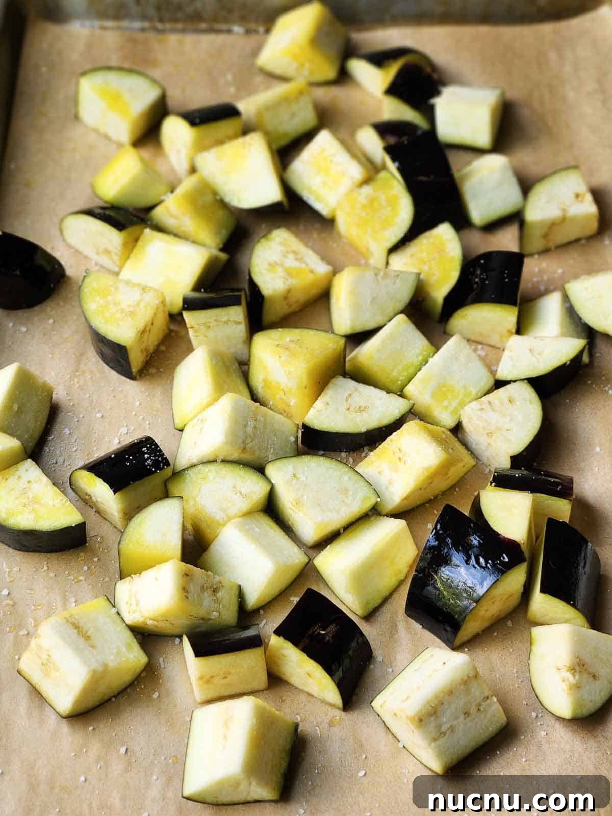 Sicilian Eggplant Caponata Recipe: Sweet-Sour Mediterranean Relish 4 Chopped eggplant on parchment paper.
