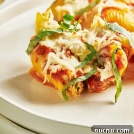 Ultimate Baked Pasta Recipes for Crowd-Pleasing Dinners 17 Stuffed Shells on a white plate.