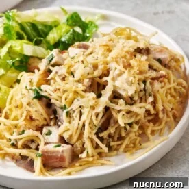 Ultimate Baked Pasta Recipes for Crowd-Pleasing Dinners 18 Turkey Tetrazzini and salad on a white plate.