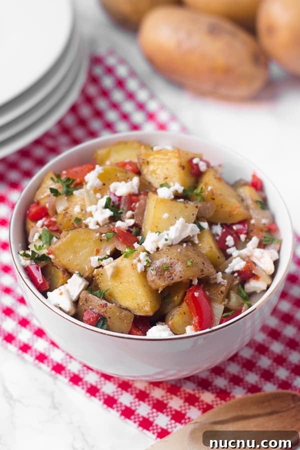 This warm roasted potato salad has a light (mayo-free!) lemon and olive oil dressing, with lots of flavor from fresh roasted red pepper and salty feta cheese