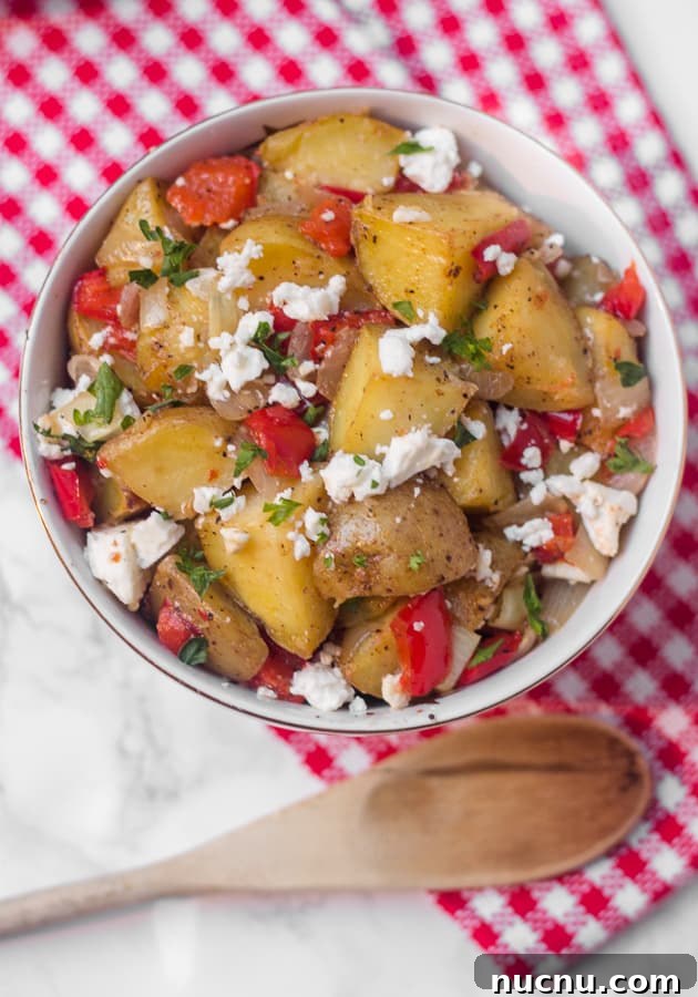 This warm roasted potato salad has a light (mayo-free!) lemon and olive oil dressing, with lots of flavor from roasted red pepper and salty feta